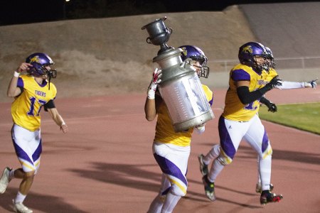 Lemoore's Preston Scott carries the Milkcan in celebration after the team's win over Hanford Friday night in Tiger Stadium.
